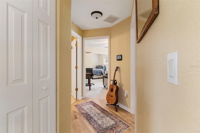 hall with light hardwood / wood-style floors