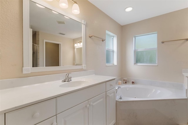 bathroom featuring vanity and separate shower and tub