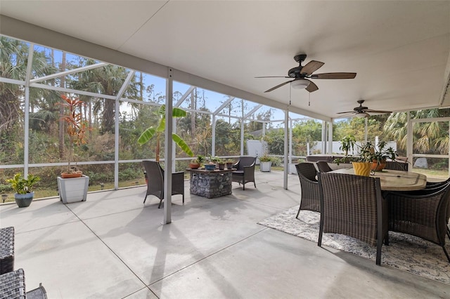 sunroom / solarium featuring ceiling fan