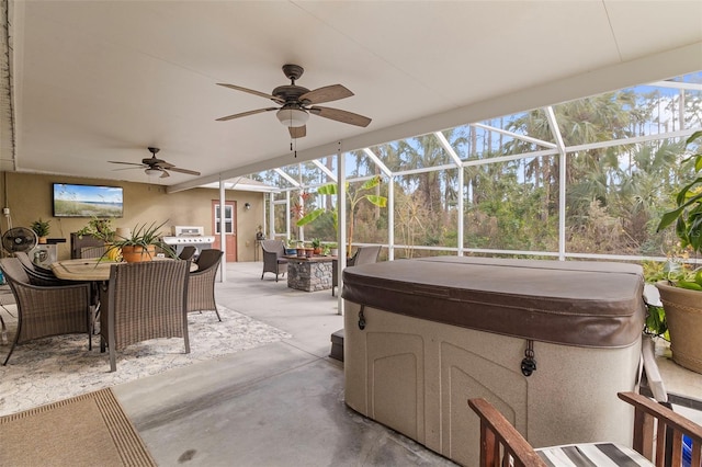 view of patio / terrace featuring ceiling fan, glass enclosure, a hot tub, and a grill