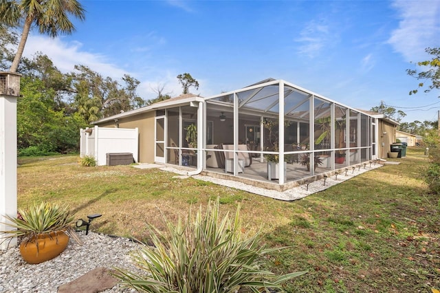 rear view of property with a patio and a lawn