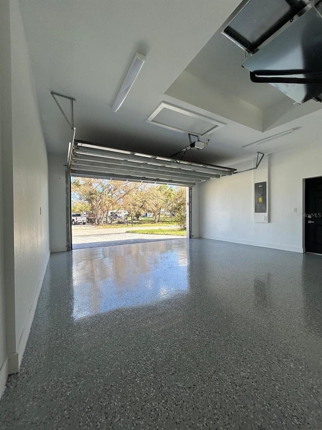 garage with electric panel and a garage door opener