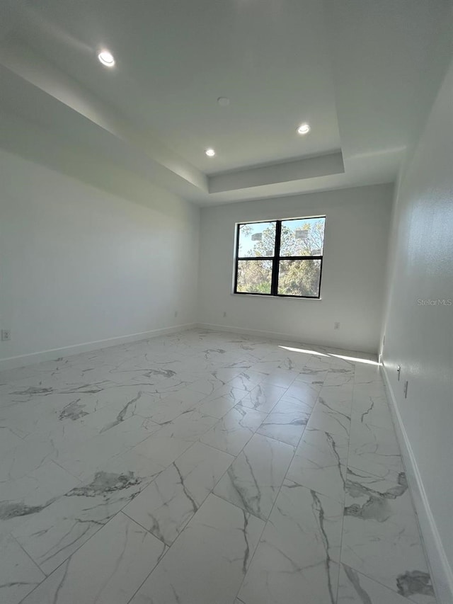 empty room featuring a tray ceiling