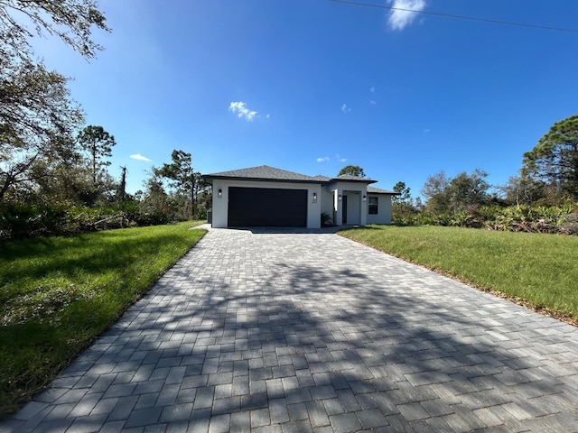 view of front of home with a front lawn and a garage