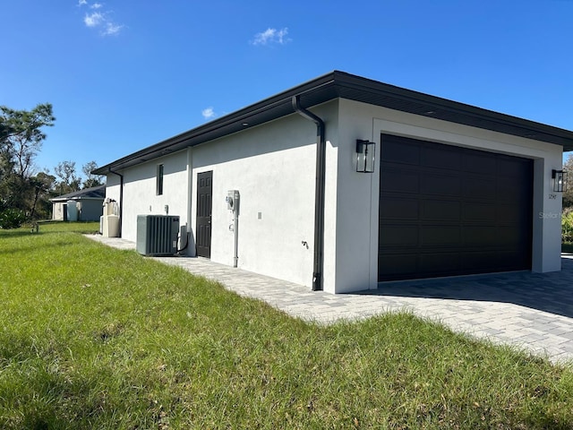 view of home's exterior featuring central air condition unit and a lawn