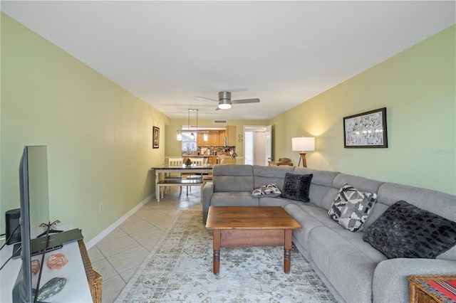 living room featuring light tile patterned flooring and ceiling fan