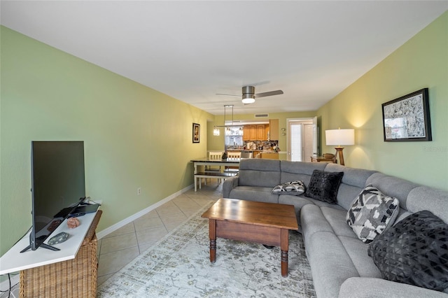 tiled living room featuring ceiling fan