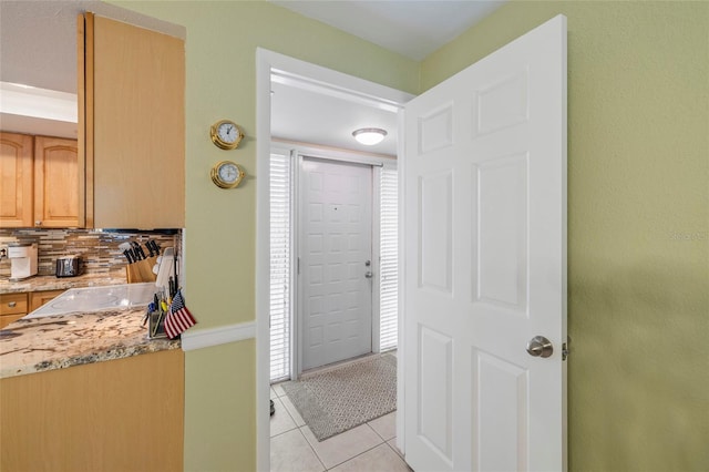 tiled foyer featuring sink