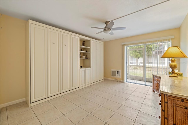 interior space featuring ceiling fan, light tile patterned floors, and heating unit