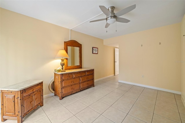 unfurnished room featuring ceiling fan and light tile patterned floors