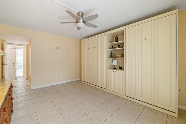 unfurnished bedroom featuring ceiling fan and light tile patterned floors