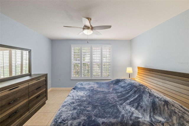 bedroom with ceiling fan and light tile patterned floors