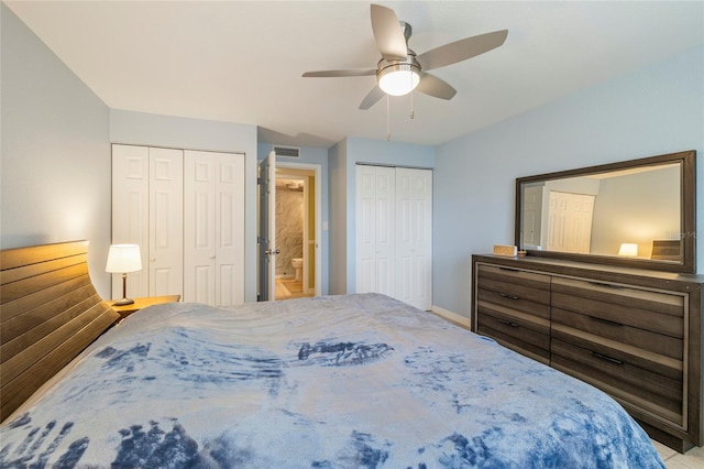 bedroom with two closets, ceiling fan, and connected bathroom