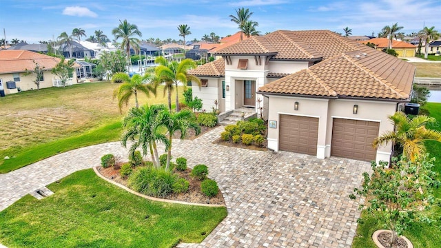 mediterranean / spanish-style house featuring a garage, a front yard, and a water view