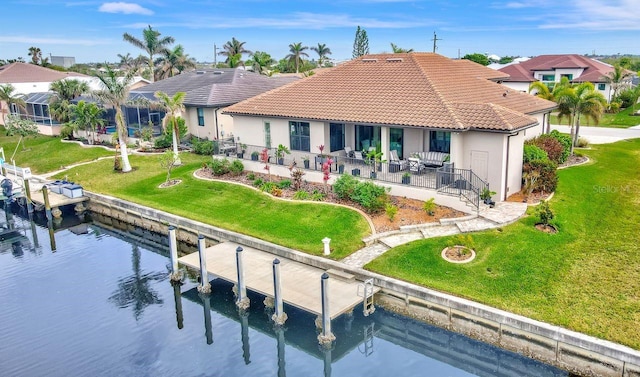 rear view of property with a patio area and a water view