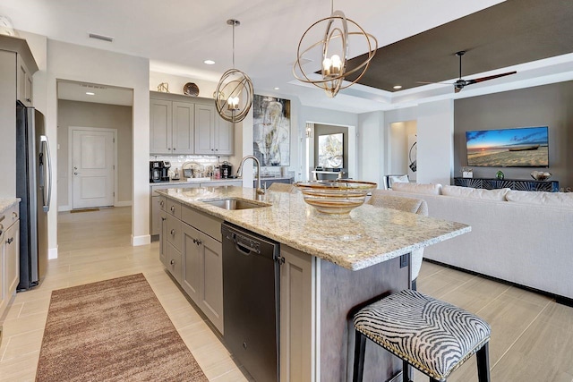 kitchen with sink, gray cabinets, dishwasher, and an island with sink