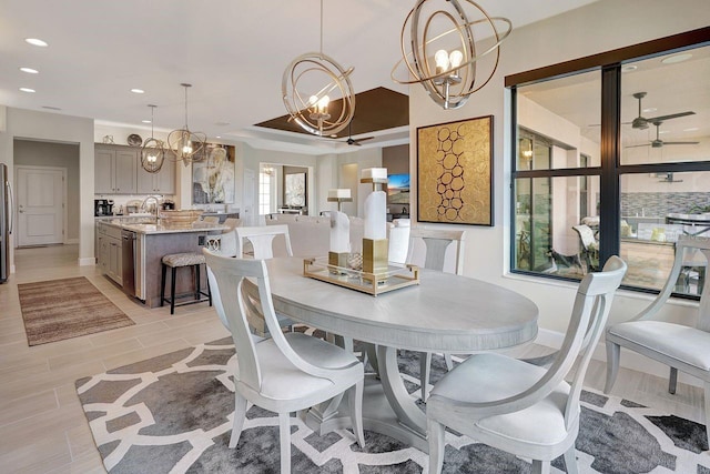 dining space featuring an inviting chandelier and sink