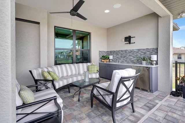 view of patio featuring an outdoor hangout area, sink, and ceiling fan