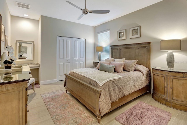 bedroom featuring ceiling fan, a closet, and light wood-type flooring