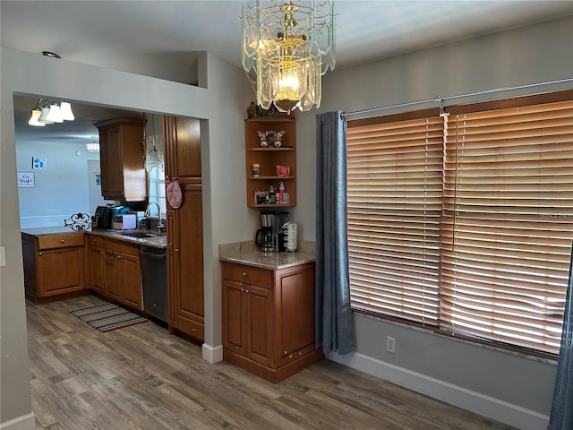 kitchen with sink, an inviting chandelier, dishwasher, dark hardwood / wood-style flooring, and pendant lighting