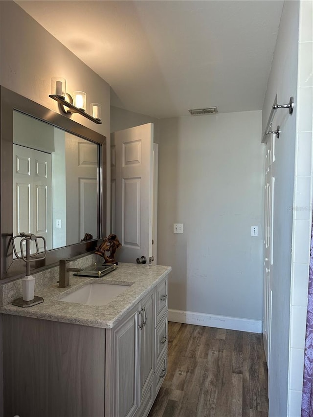 bathroom with hardwood / wood-style floors and vanity