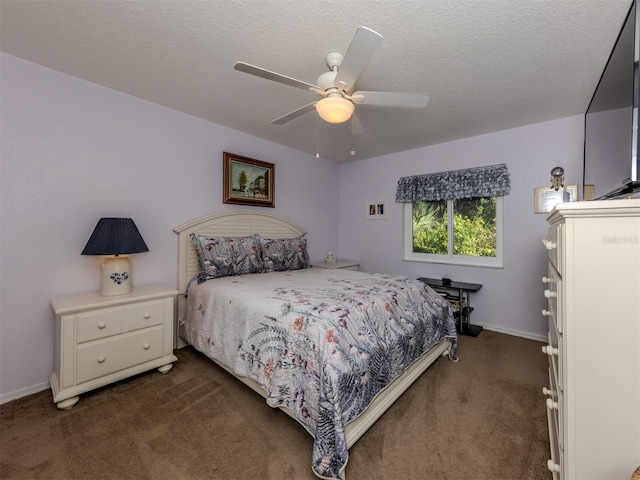 carpeted bedroom featuring a textured ceiling and ceiling fan