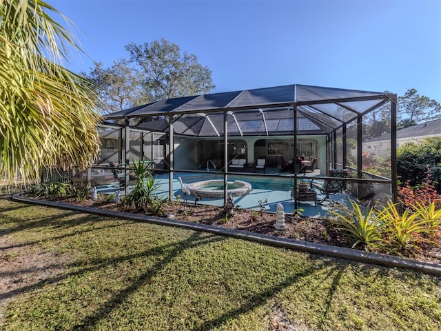 view of pool featuring a patio area, a pool with connected hot tub, glass enclosure, and a lawn