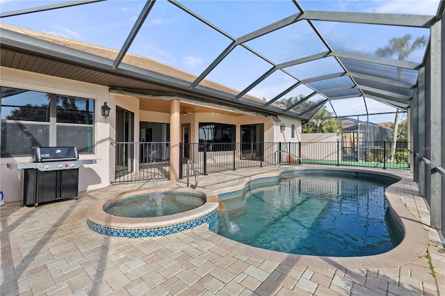 view of swimming pool with an in ground hot tub, area for grilling, a patio, and glass enclosure