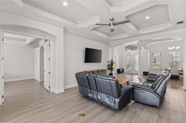 living room with french doors, coffered ceiling, ceiling fan with notable chandelier, crown molding, and light hardwood / wood-style flooring