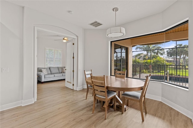 dining space with light hardwood / wood-style flooring and ceiling fan