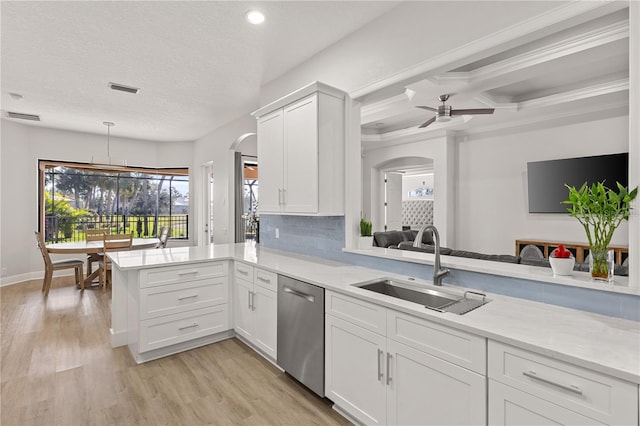 kitchen featuring kitchen peninsula, ceiling fan, sink, dishwasher, and white cabinets