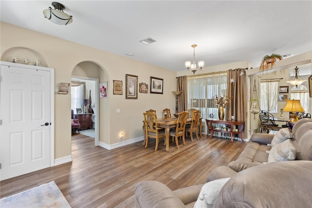 living room with hardwood / wood-style flooring and a chandelier