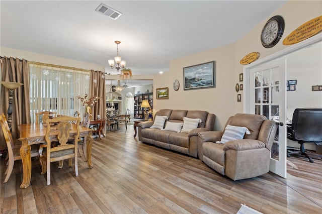 living room featuring light hardwood / wood-style flooring and a notable chandelier