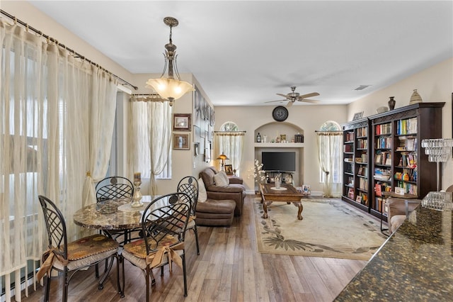 living area with ceiling fan and hardwood / wood-style floors