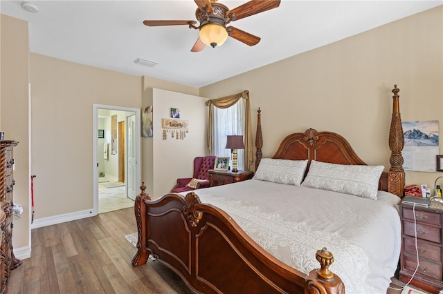 bedroom with hardwood / wood-style floors, ensuite bath, and ceiling fan