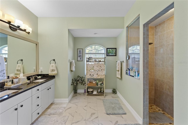 bathroom with vanity and tiled shower