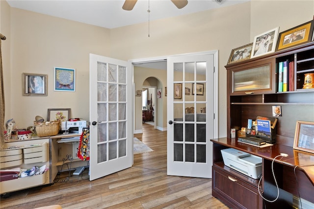 home office featuring ceiling fan, light wood-type flooring, and french doors