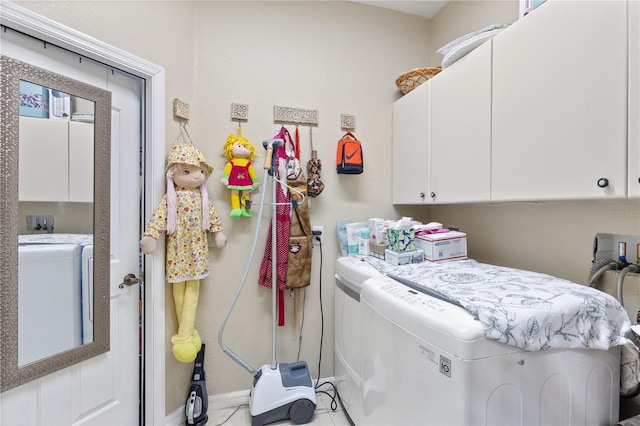 washroom with cabinets and separate washer and dryer