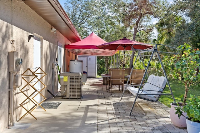 view of patio / terrace with water heater and cooling unit