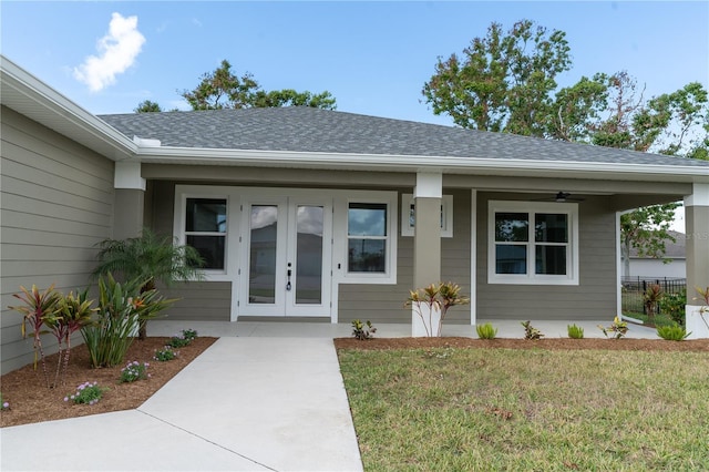 property entrance with a yard and ceiling fan