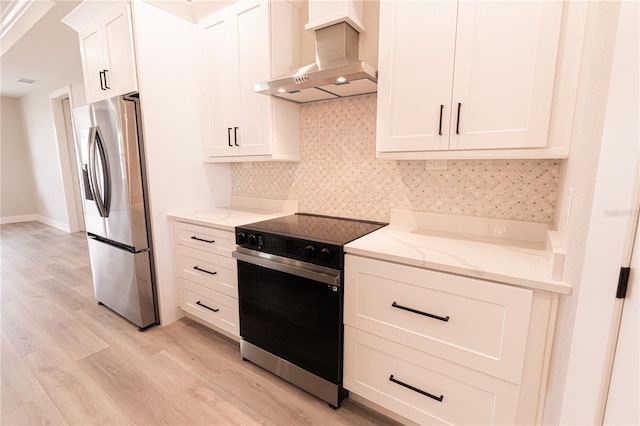 kitchen featuring electric range, light stone counters, ventilation hood, light hardwood / wood-style floors, and stainless steel fridge with ice dispenser