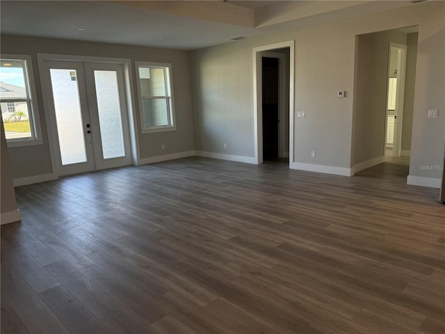 spare room featuring dark hardwood / wood-style flooring and french doors