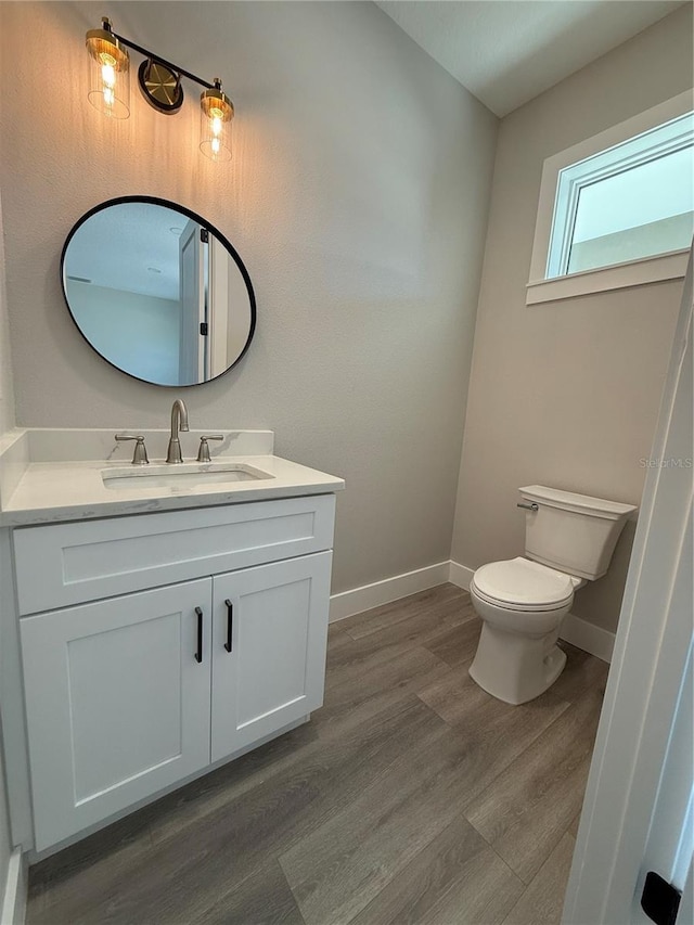 bathroom with vanity, hardwood / wood-style floors, and toilet