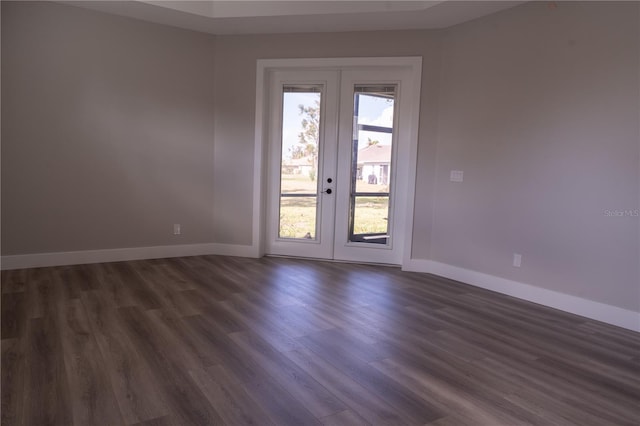 empty room with dark wood-type flooring and french doors