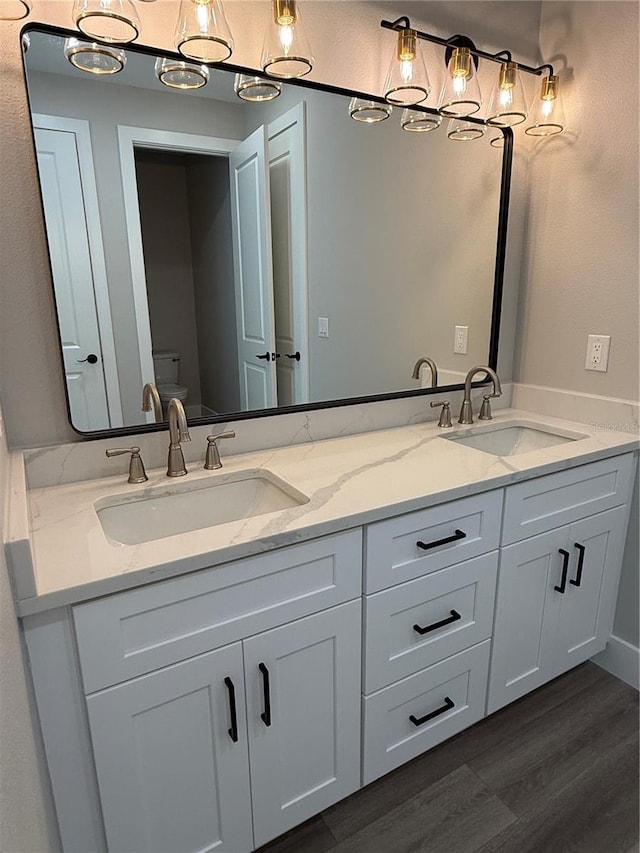 bathroom featuring hardwood / wood-style flooring, vanity, and toilet