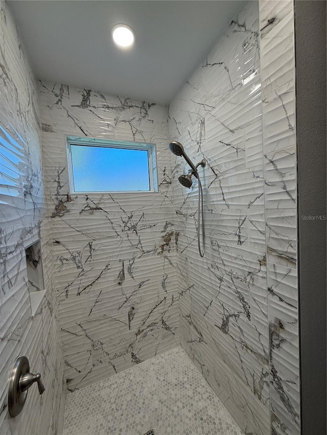 bathroom with a tile shower