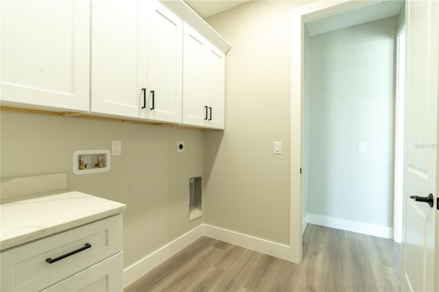 washroom with cabinets, hookup for a washing machine, hookup for an electric dryer, and light hardwood / wood-style floors