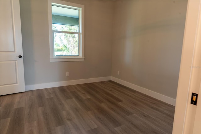 empty room featuring dark hardwood / wood-style flooring