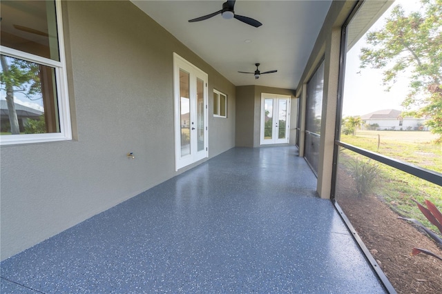 unfurnished sunroom featuring french doors and ceiling fan