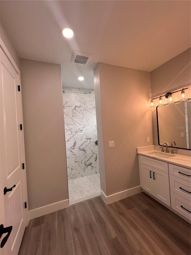 bathroom with vanity, hardwood / wood-style floors, and walk in shower